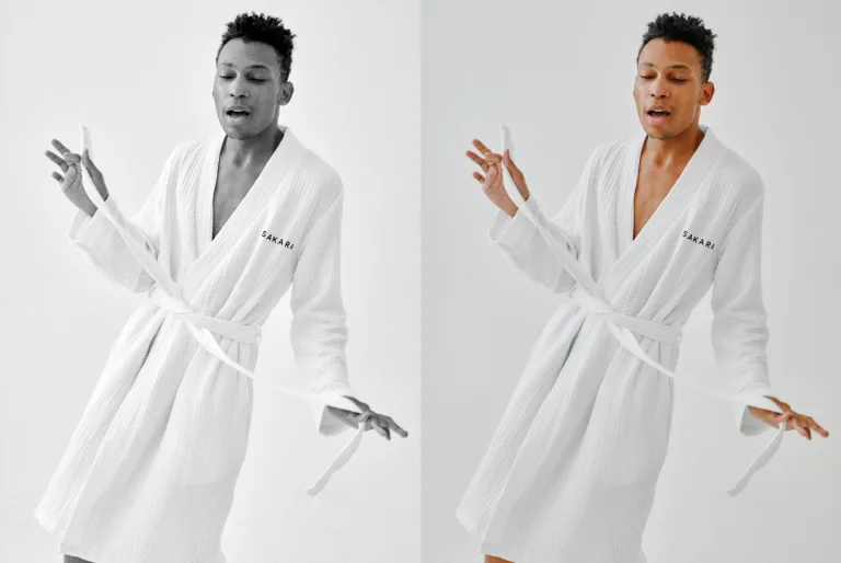 Person in a white robe gesturing with hands against a white background.
