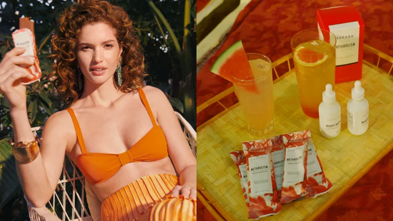 Woman in an orange swimsuit holding a small bottle while seated beside a tray with drinks and packaged Sakara supplements.