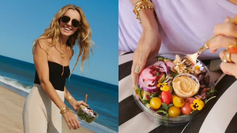Woman walking along a beach holding a Sakara salad bowl.