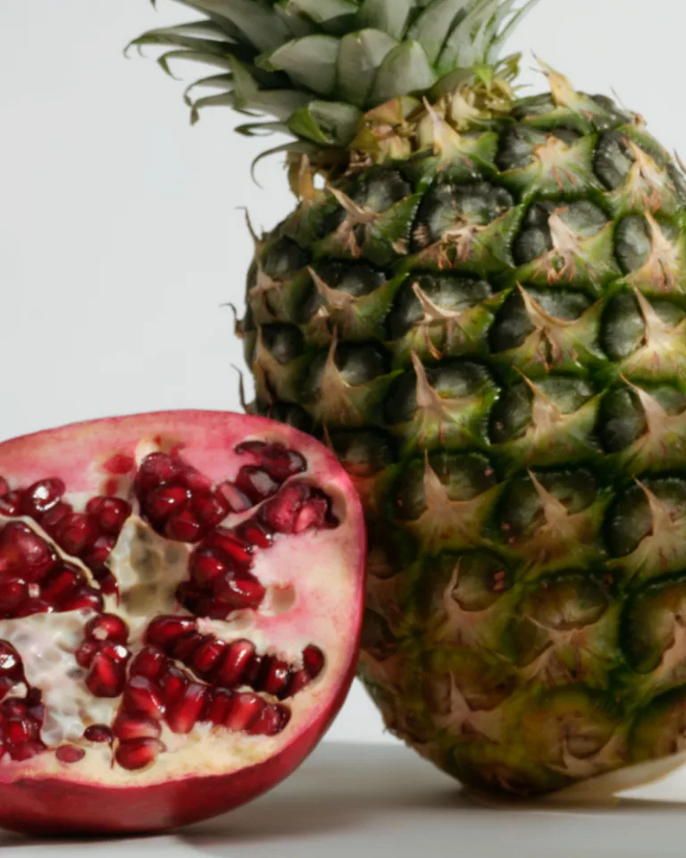 Close-up of fresh pineapple and halved pomegranate representing whole-food ingredients in Sakara Fiber Super Powder