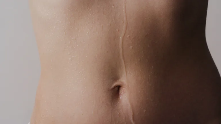 Close-up of a wet torso with water droplets on skin.