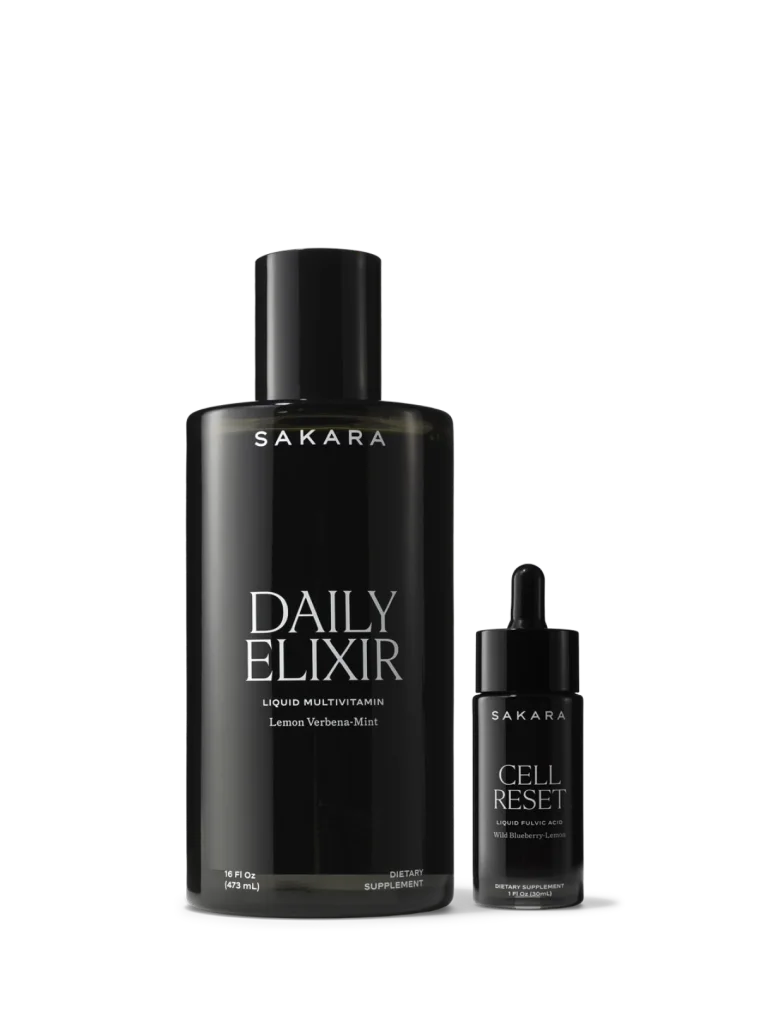 Black bottles of Sakara Daily Elixir liquid multivitamin and Cell Reset liquid multivitamin displayed side by side on a white background.