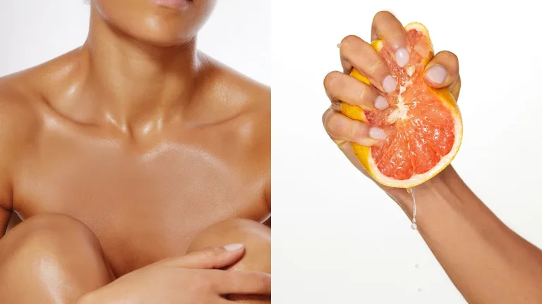 Oiled skin close-up with a hand squeezing half a grapefruit.